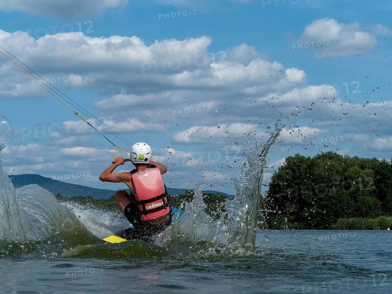Young man jumping into the water with a wakeboard, Water ski and wake park, Water sports, Stráž pod Ralskem, Jizera Mountains, Czech Republic, Europe