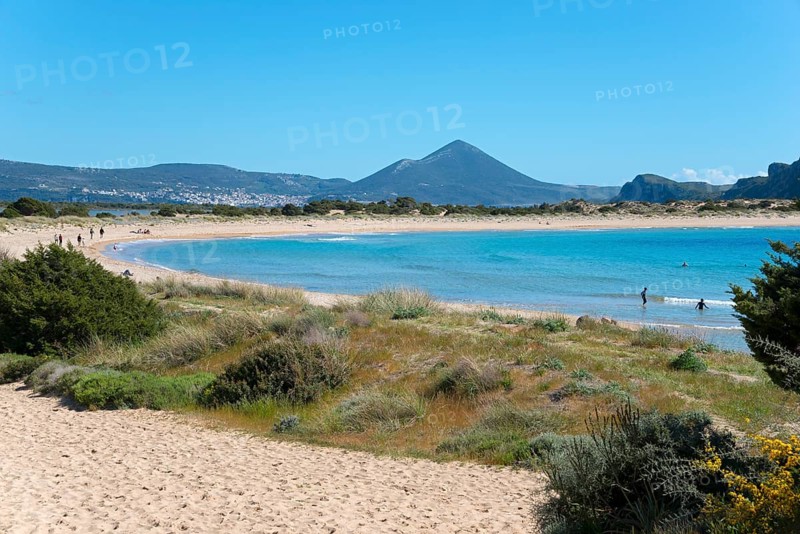 An idyllic beach with clear blue water and mountains in the background on a sunny day, Voidokilia Bay, Voidokilia Bay, Oxbelly Bay, Pylos, Messinia, Peloponnese, Greece, Europe