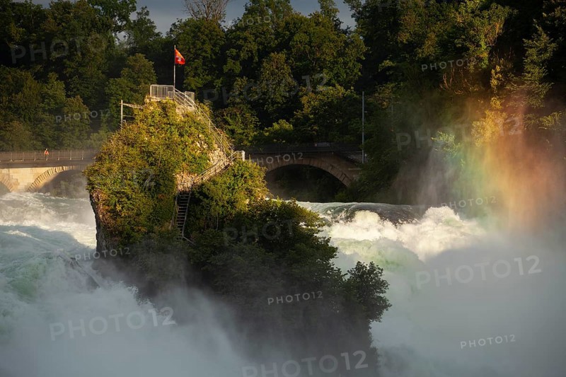 The Rhine Falls at Schaffhausen in Switzerland with rainbow colours and the Middle Rock. An extreme amount of water in 2024