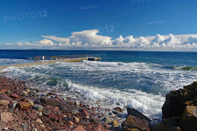 Coastal landscape with stormy waves on a rocky shore under a cloudy blue sky, Tönsberg, Oslofjord, Norway, Europe