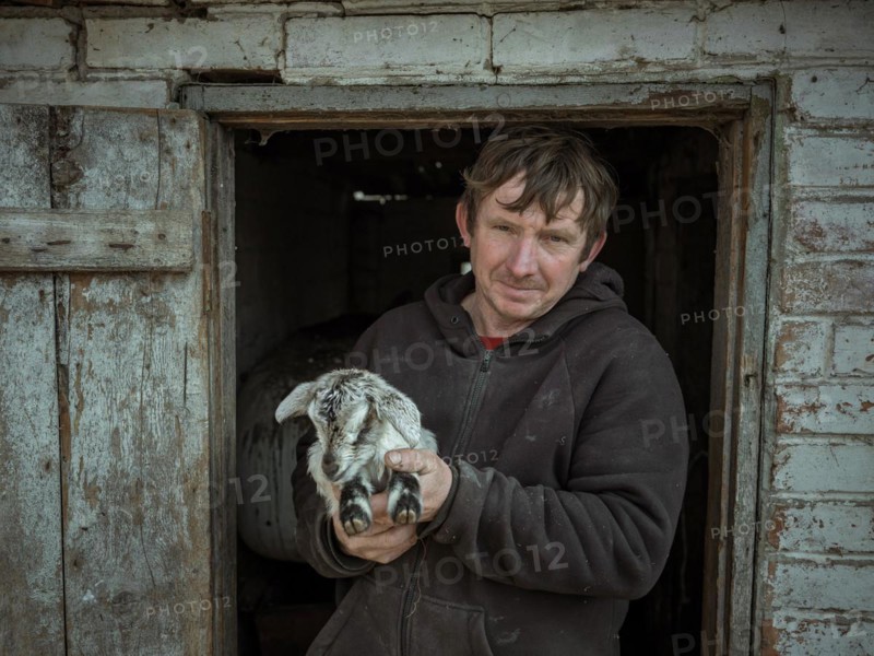 Vova, 46 years old, farmer from Borshchivka with a goatling. The village was under Russian occupation for 6 months. Viva and his family hid on the farm, Borshchivka, Kharkiv, Ukraine, Europe