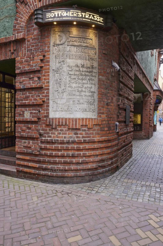 Illuminated sign Böttcherstrasse and information sign embedded in the house wall for the artist Paula Modersohn-Becker in Böttcherstrasse in Bremen, Hanseatic City, State of Bremen, Germany, Europe