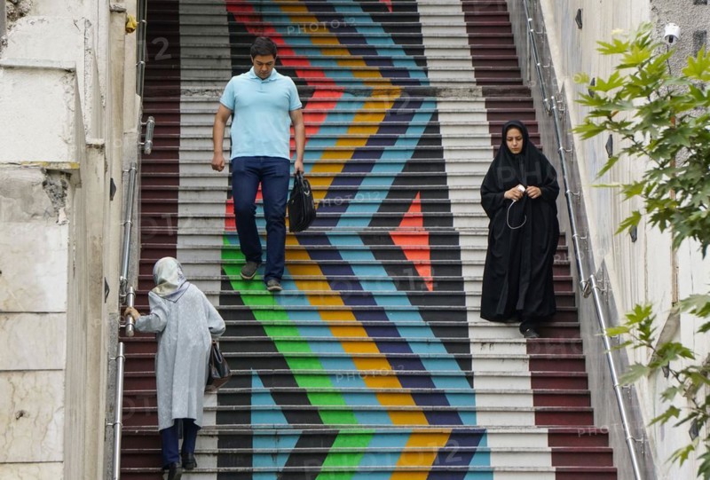 People walk down a painted staircase. The city of Tehran is changing the image of the city through art objects in public spaces, 21/05/2016