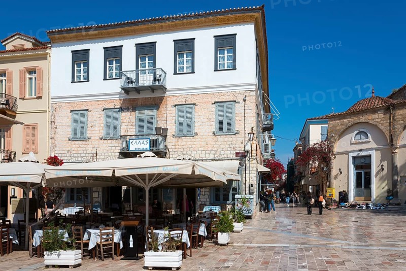 A square with a historic building, café with parasols and Mediterranean flair under a blue sky, Syntagma Square, Nafplio, Nafplio, Nafplion, Argolis, Peloponnese, Greece, Europe