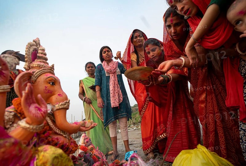 Devotees offer prayers to the Ganesha idol before immerse in the Brahmaputra river, during Ganesh Chaturthi festival, in Guwahati, Assam, India on Saturday, 9 Sept 2024