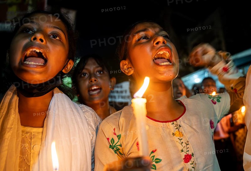 Students holds candle and shout slogans as they participate in a protest against the rape and murder of a doctor inside a hospital in Kolkata, on August 18, 2024 in Guwahati, India. A trainee doctor, 31, was attacked at RG Kar Medical College and Hospital in Kolkata, the capital of West Bengal, last week