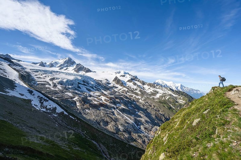 Mountaineer on a hiking trail, view of high alpine mountain landscape, summit of Aiguille de Chardonnet and Glacier du Tour, glacier and mountain peak, Chamonix, Haute-Savoie, France, Europe