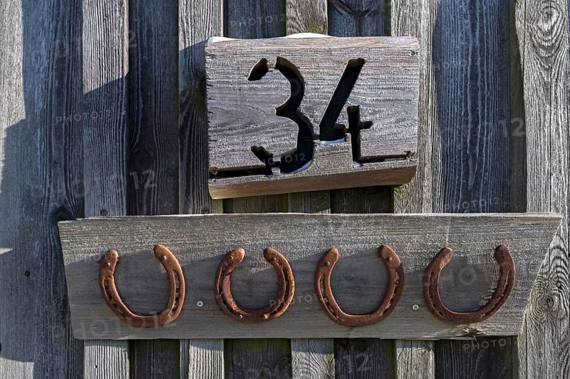 Horseshoe under a house number on a barn, Bavaria, Germany, Europe
