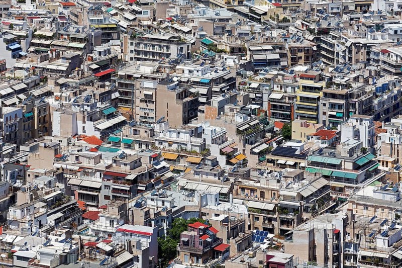 View of densely built-up metropolis, sea of houses without greenery, colourful awnings, symbolic image concrete desert, Athens, Greece, Europe