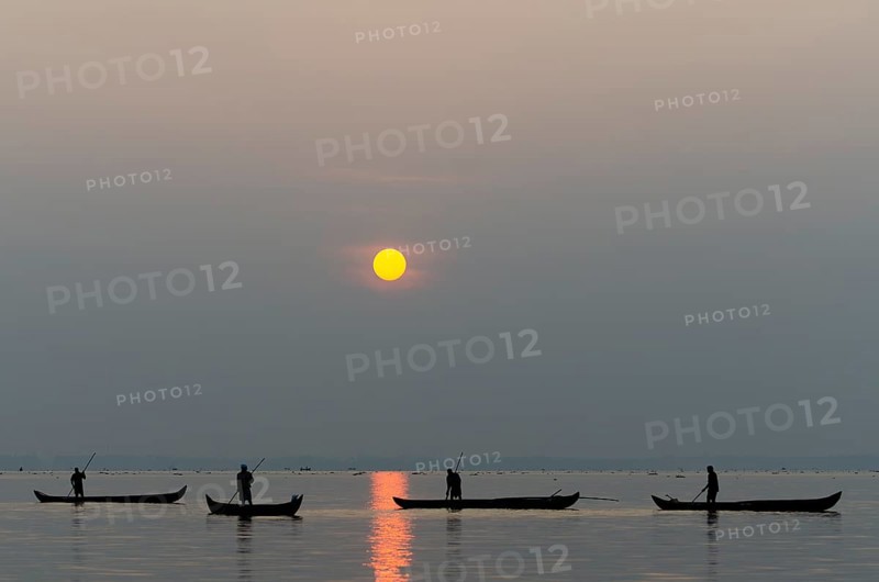 Fishermen on the Vembanad Lake at sunrise, Kerala, South India, India, Asia