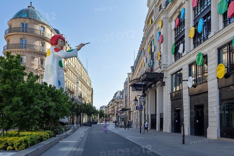 Modern art installation with large statue and colourful façade in an urban setting, Paris
