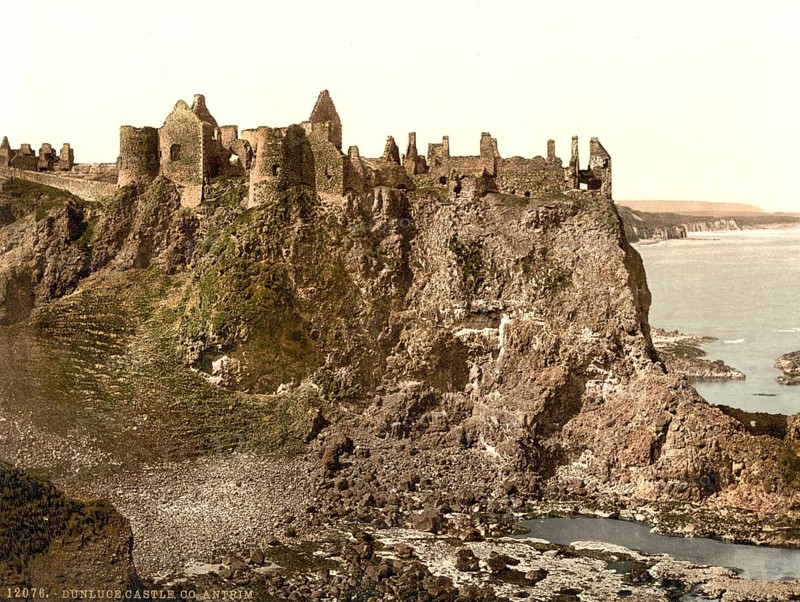 Dunluce Castle, one of the largest ruins of a medieval castle in Ireland. It is located on a basalt rock on the rugged north coast of the island, between the villages of Portballintrae and Portrush in County Antrim in Northern Ireland, Historic, digitally restored reproduction from a 19th century original, Record date not stated