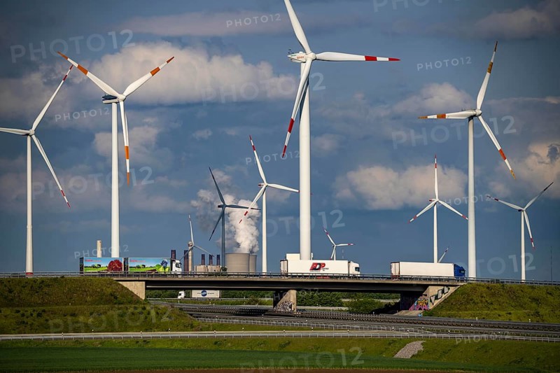 RWE Windpark Jüchen A44n, Garzweiler wind farm, at the Garzweiler opencast lignite mine, on the A44 motorway, Jackerath motorway junction, including Nordex N149 wind turbines, located on recultivated areas of the opencast lignite mine, in the background the RWE Power Neurath coal-fired power station, North Rhine-Westphalia, Germany, Europe