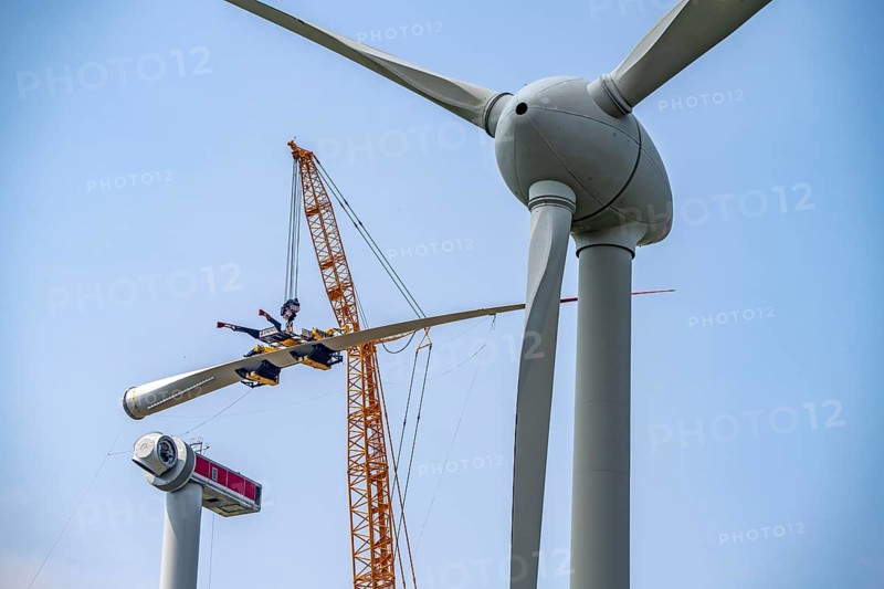 Erection of an Enercon E-160 wind turbine, rear, assembly of the first blade, 4 turbines with a total output of 22 megawatts replace 9 older wind turbines from the manufacturer Enercon (E-58 model series), front, they were in operation for over two decades, Lower Rhine, North Rhine-Westphalia, Germany, Europe