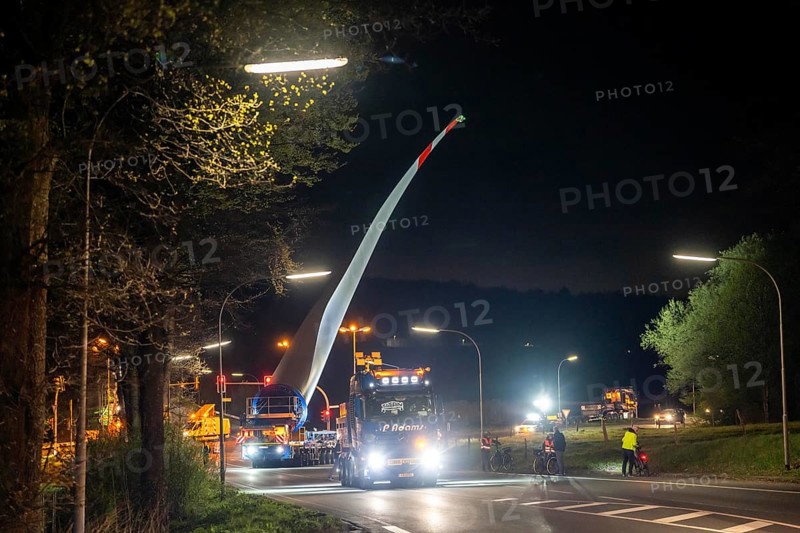 Transport of a 68 metre long, 22 tonne blade of a wind turbine, here in Schwelm, with a self-propelled Blade-Lifter vehicle, over a 40 km long route, over 2 nights, in the Bergisches Land, through towns, villages, over country roads, narrow through roads, to the construction site of the wind turbine near Hagen, North Rhine-Westphalia, Germany, Europe
