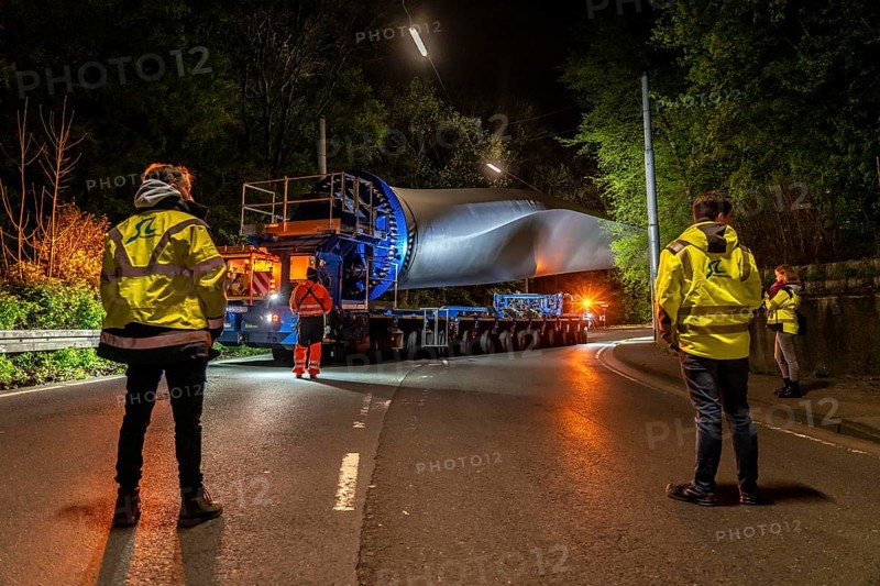 Transport of a 68 metre long, 22 tonne blade of a wind turbine, here in Schwelm, with a self-propelled Blade-Lifter vehicle, over a 40 km long route, over 2 nights, in the Bergisches Land, through towns, villages, over country roads, narrow through roads, to the construction site of the wind turbine near Hagen, North Rhine-Westphalia, Germany, Europe