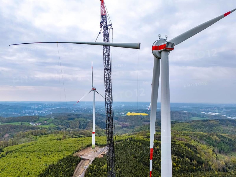 Erection of a wind turbine, wind energy plant, assembly of the third blade, with a crawler lattice crane, wind farm near Hagen, North Rhine-Westphalia, Germany, Europe