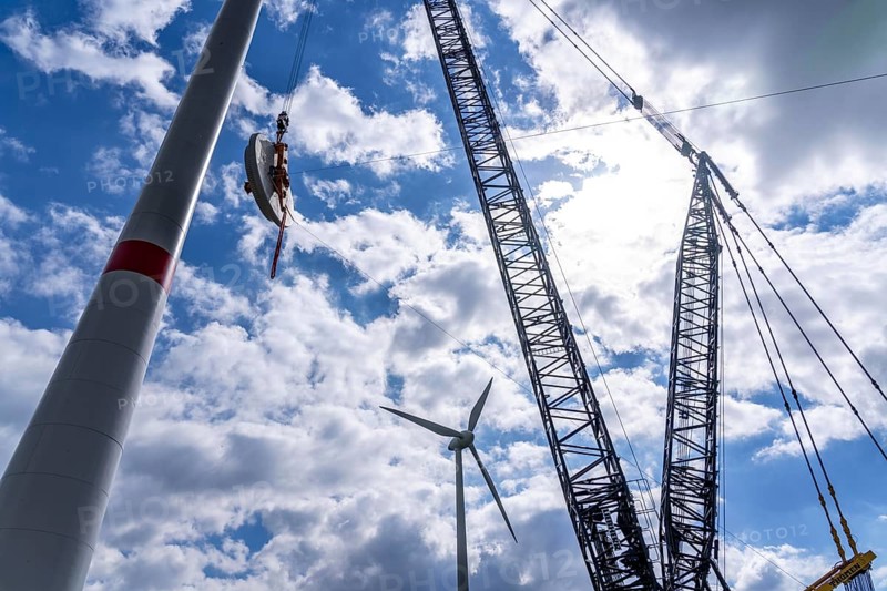 Erection of a wind turbine, wind energy plant, assembly of the ring generator, with a crawler lattice crane, wind farm near Hagen, North Rhine-Westphalia, Germany, Europe