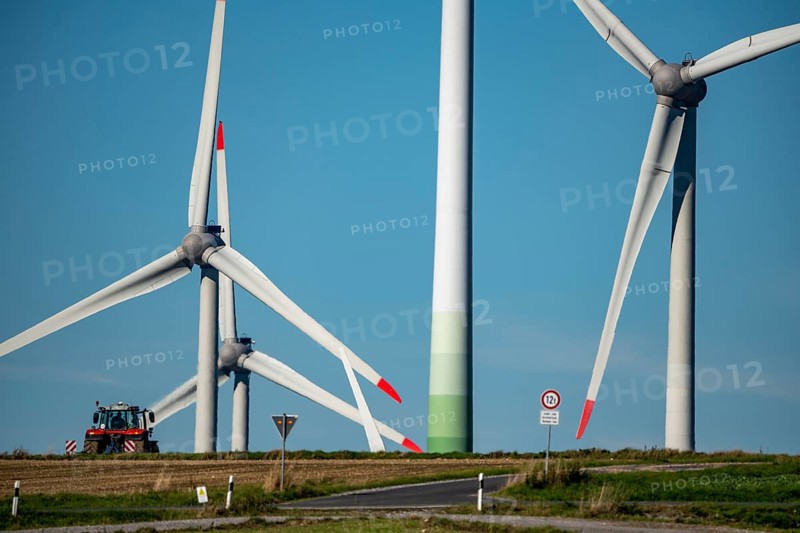 Wind farm near Lichtenau, wind turbines, country road, Driburger Straße, tractor at work in the field, North Rhine-Westphalia, Germany, Europe