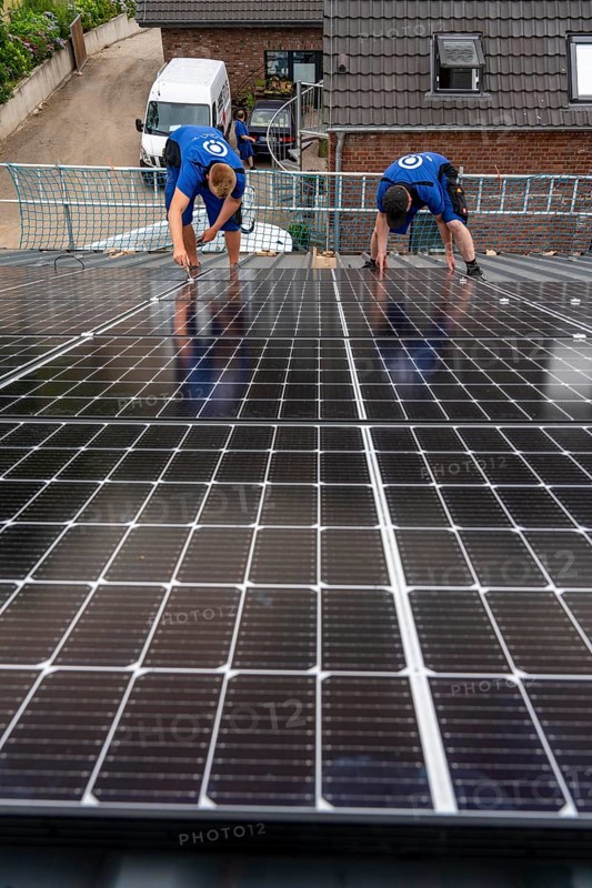Installation of solar modules on the roof of a barn on a farm, over 240 photovoltaic modules are installed on the roof, North Rhine-Westphalia, Germany, Europe