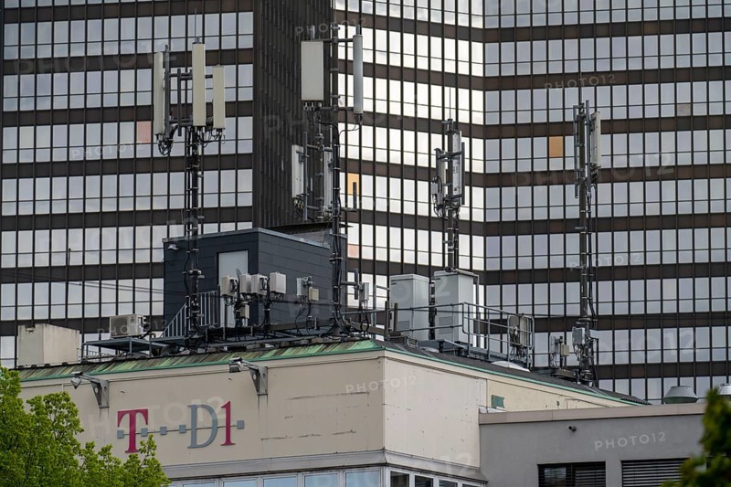 Antennas for mobile radio, on a building in the city centre of Essen, in the background the town hall, North Rhine-Westphalia, Germany, Europe
