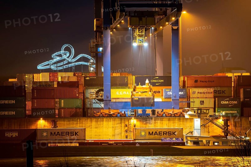 Container Handling Centre, Gateway West Terminal, Logport 2, cargo ship, in Duisburg on the Rhine, in the background Tiger and Turtle - Magic Mountain is a landmark modelled on a roller coaster on Heinrich-Hildebrand-Höhe in Angerpark in Duisburg-Angerhausen, North Rhine-Westphalia, Germany, Europe