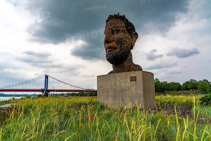 The sculpture Echo of Poseidon, Since 2016, the 10 m high sculpture by Markus Lüpertz has been standing on Mercatorinsel, the sculpture was erected from 75 individual parts on the occasion of the 300th harbour birthday, Friedrich-Ebert-Brücke over the Rhine, Duisburg, North Rhine-Westphalia, Germany, Europe