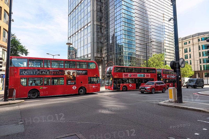 City scene with several red double-decker buses and modern skyscrapers in London, United Kingdom United Kingdom