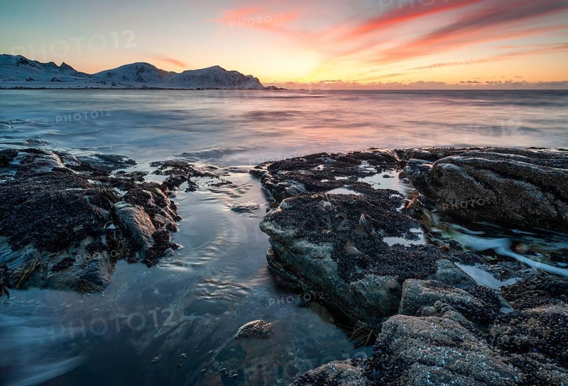 Sunset in winter at Skagsanden, rock formations on the beach at Flakstad, Flakstadøy, Lofoten, Nordland, Norway, Europe