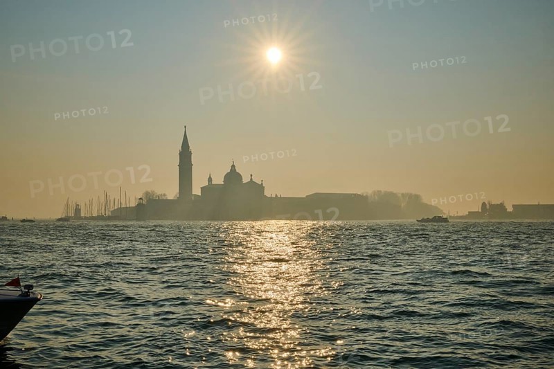 View from 'Colonna di San Marco e San Teodoro' on church 'Giorgio Maggiore' on a foggy morning at sunrise in Venice in winter, Italy, Europe
