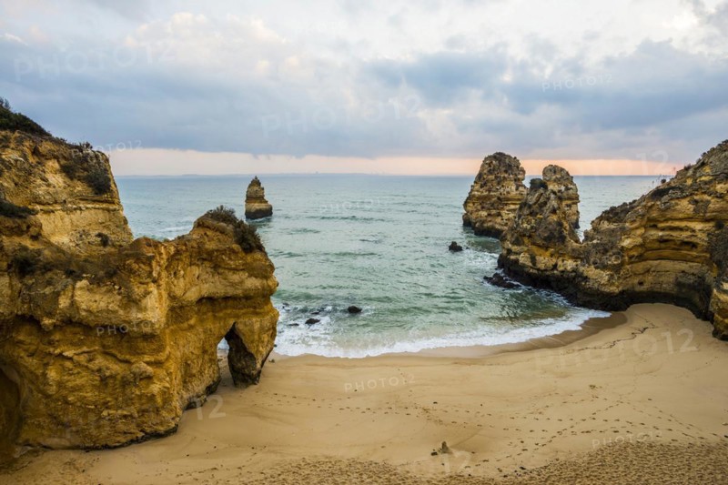 Rocky coast with beach and red rocks, Praia do Camilo, Lagos, Algarve, Portugal, Europe