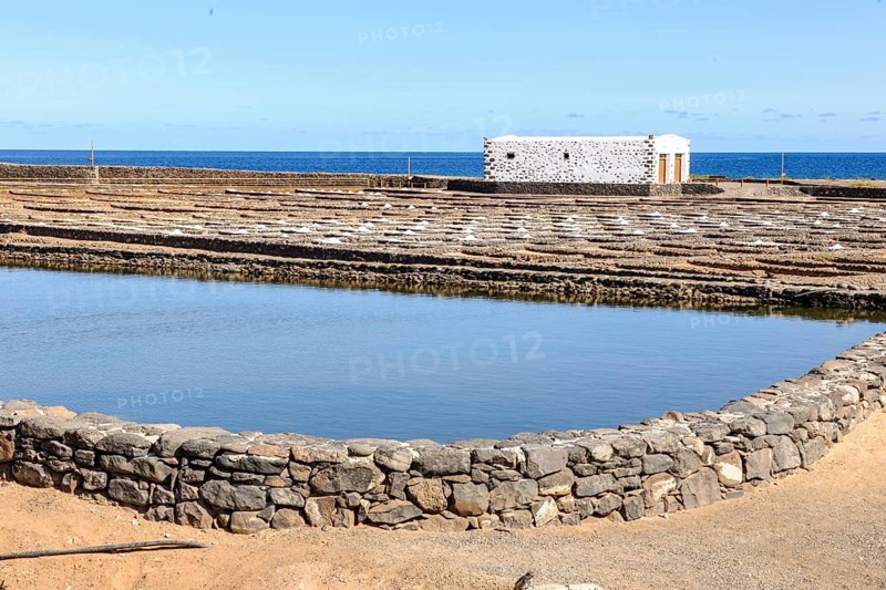 Historic salt works for salt extraction, today the salt museum Museo de la Sal, in the foreground collecting basin for water, in the background small reservoirs for the evaporation of salt water, next to it skimmed sea salt, on the horizon open sea East Atlantic, Antigua, Fuerteventura, Canary Islands, Spain, Europe