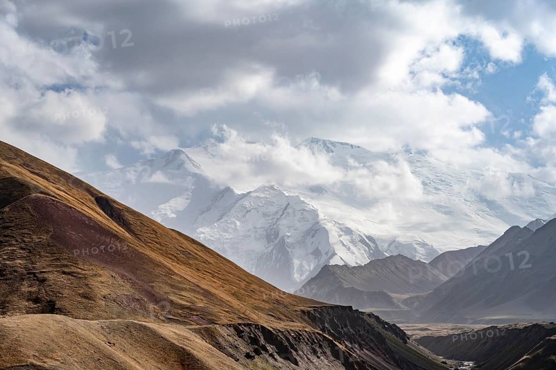Dramatic mountain landscape, mountain valley, behind glaciated and snow-covered mountain peak Pik Lenin, Trans Alay Mountains, Pamir Mountains, Osh Province, Kyrgyzstan, Asia