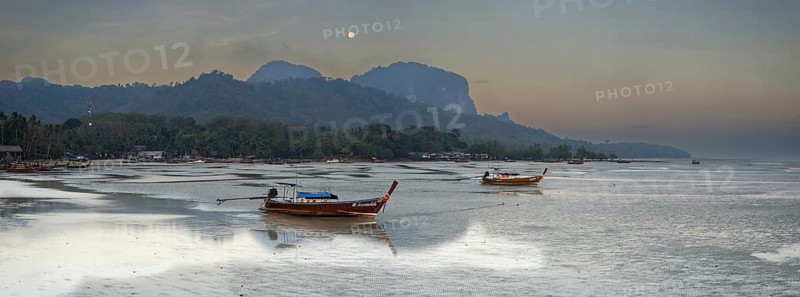 Before sunrise, longtail boats lie at low tide in the harbour at Sivalai Beach, Koh Mook Island, Satun Province, Southern Thailand, Thailand, Asia