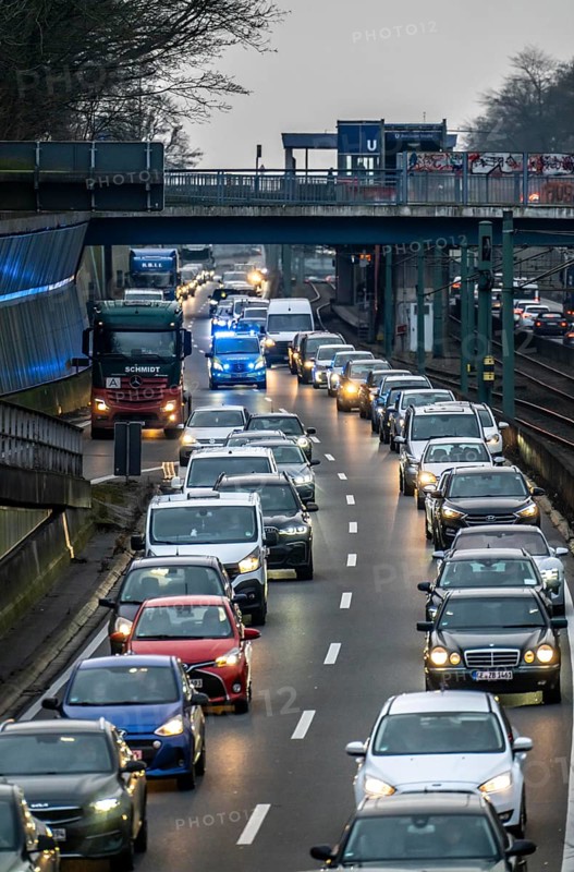 Traffic jam on the A40 motorway, emergency lane, vehicles on the left and right, police patrol car with flashing blue lights and siren, Essen, North Rhine-Westphalia, Germany, Europe