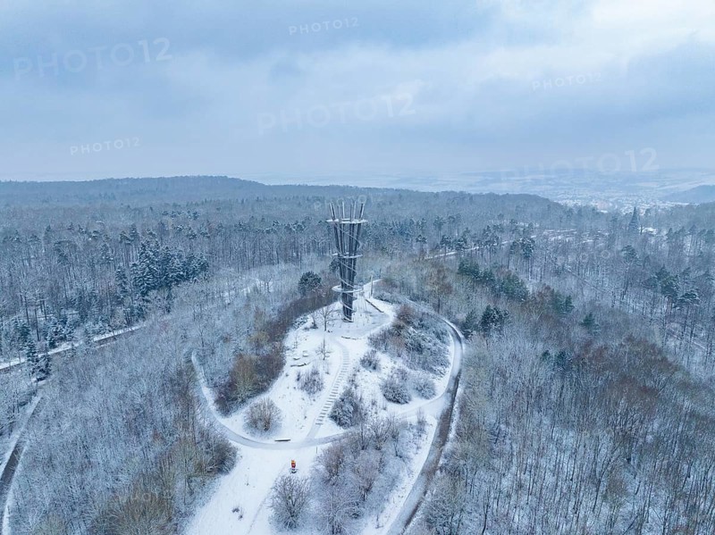 Snow-covered paths lead to a tower in a wintry wooded area, cool atmosphere, Schönbuchturm, Herrenberg, Germany, Europe