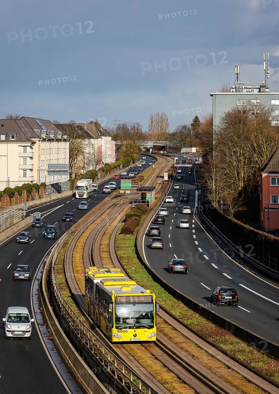 Essen, North Rhine-Westphalia, Germany - Cars and a public bus drive through Essen city centre on the A40 motorway