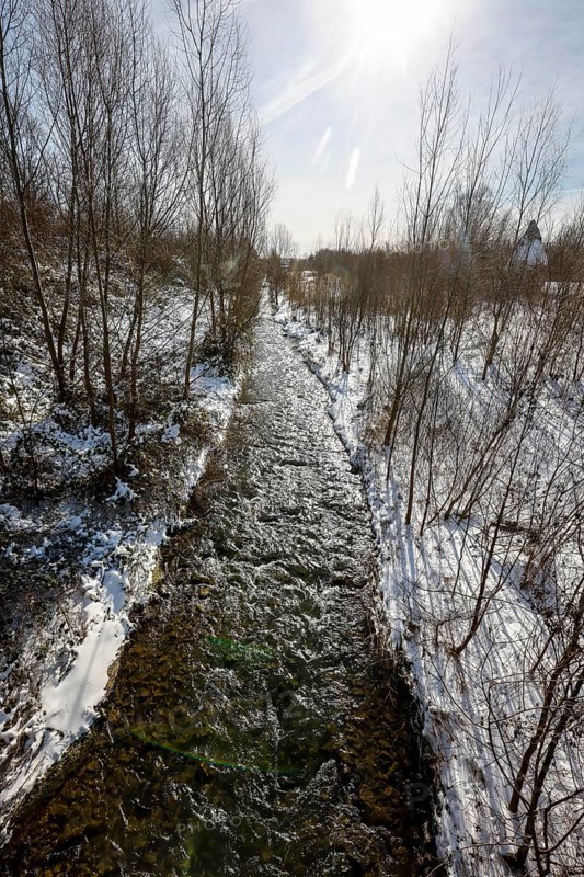 Dortmund, North Rhine-Westphalia, Germany - Sunny winter landscape in the Ruhr area, ice and snow on the renaturalised Emscher, the ecological conversion of the Emscher system consists of the construction of a central wastewater treatment system in the Ruhr area, the construction of underground sewers and the renaturalisation of the Emscher and its tributaries