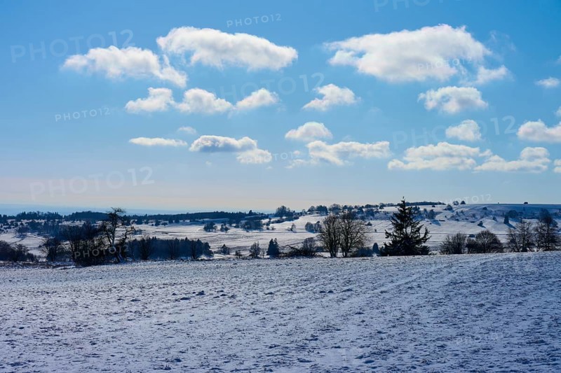Bright winter landscape with clouds and a clear blue sky over snow-covered fields, Winter, Oberelsbach, Lange Rhön, Rhön, Bavaria, Germany, Europe