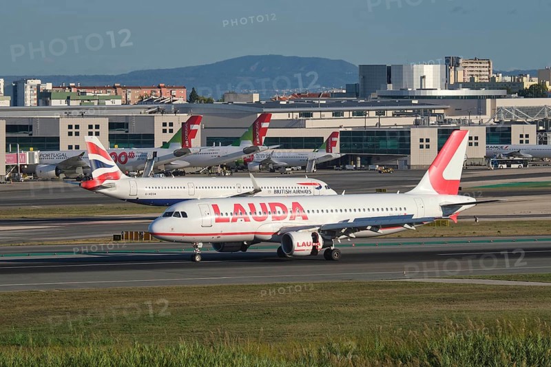 Lisbon, Portugal - September 2, 2023: Lauda Europe Airbus A320-214 passenger plane taxi on runway in Humberto Delgado Airport in Lisbon