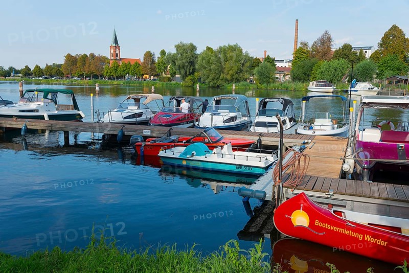 A harbour with several boats and a church in the background, Maria Meeresstern church, old town island of Werder in der Havel, Potsdam-Mittelmark, Brandenburg, Germany, Europe