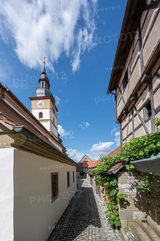 Inner courtyard with wine cellars and St John's Church in the historic fortified church, Hüttenheim, Lower Franconia, Bavaria, Germany, Europe
