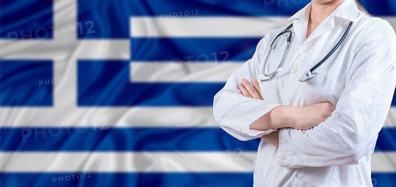 Doctor with crossed arms on Greek flag. Greece Health and Care concept. Female doctor on Greek flag