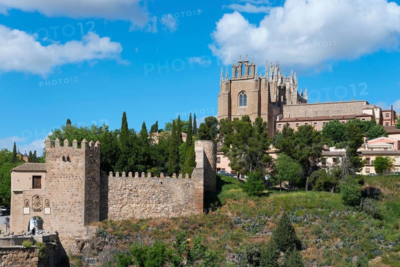 Medieval cityscape with church, city walls and trees under a blue sky with clouds, Puente de San Martín, St Martin's Bridge, monastery on the right, Monasterio de San Juan de los Reyes, Toledo, Castilla-La Mancha, Spain, Europe