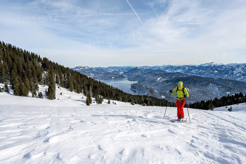 Ski tourers climbing Simetsberg, view of Walchensee, Estergebirge, Bavarian Prealps, Bavaria Germany