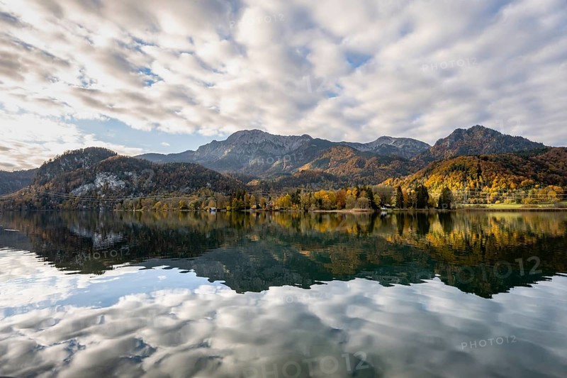 Autumnal mountain landscape with mountain peaks Herzogstand and Heimgarten, reflection in Lake Kochel, Upper Bavaria, Bavaria, Germany, Europe