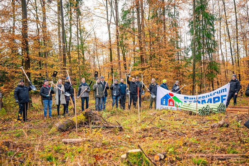 Group posing for a photo with a banner in autumn forest, tree planting campaign, Waldbike Calw, district of Calw, Black Forest, Germany, Europe