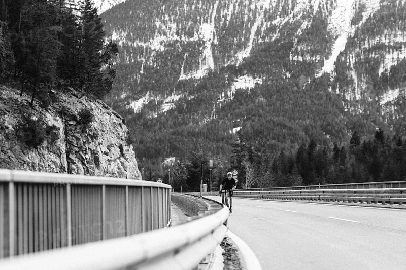 Road bike rider in spring in the Allgäu against the picturesque backdrop of the Alps, Bavaria, Germany, Europe