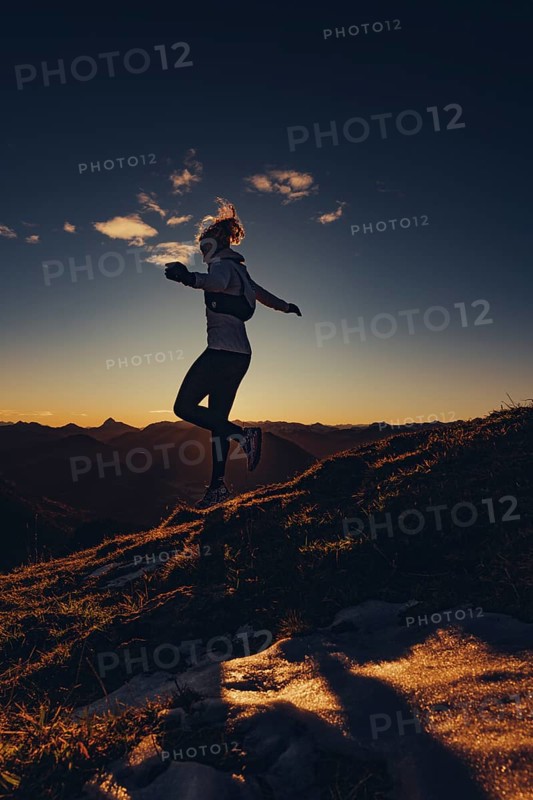 Trail running in autumn on the Jochberg on Lake Walchensee against the wonderful backdrop of the Alps, Bavaria, Germany, Europe