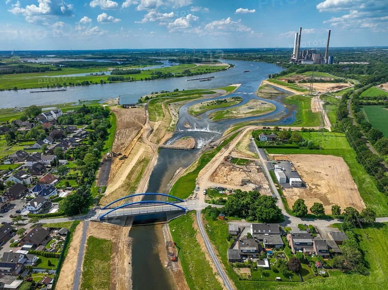 Dinslaken, Voerde, North Rhine-Westphalia, Germany, Renaturalisation of the Emscher. New Emscher estuary into the Rhine. Flood protection through land expansion. The decommissioned STEAG coal-fired power station in Voerde in the background. The mouth of the Emscher into the Rhine was moved from Dinslaken to Voerde, almost 500 metres to the north. Fish can now swim barrier-free up the new Emscher from the Rhine through a newly created floodplain area. Following the construction of a parallel sewer, the Emscher has been completely free of sewage since January 2022. The river was previously an open, above-ground combined sewer with rainwater and wastewater, Europe